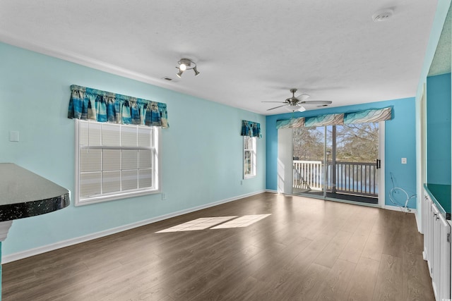 561 White River Dr Unit 11-D, Myrtle Beach, SC 29579 - empty room with wood finished floors, ceiling fan, a smoke detector, baseboards, and a textured ceiling
