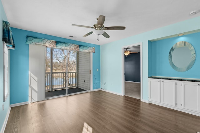 561 White River Dr Unit 11-D, Myrtle Beach, SC 29579 - empty room featuring a smoke detector, ceiling fan, dark wood-type flooring, baseboards, and a water view