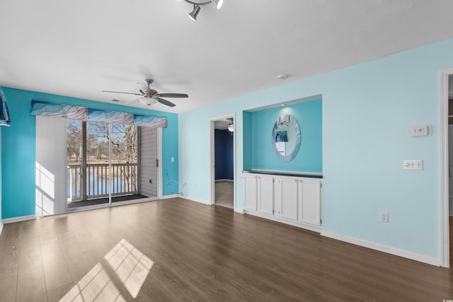 561 White River Dr Unit 11-D, Myrtle Beach, SC 29579 - unfurnished living room with dark wood finished floors, a ceiling fan, and baseboards