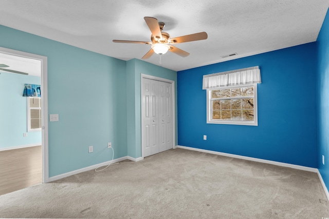 561 White River Dr Unit 11-D, Myrtle Beach, SC 29579 - unfurnished bedroom with carpet, baseboards, a closet, a ceiling fan, and a textured ceiling