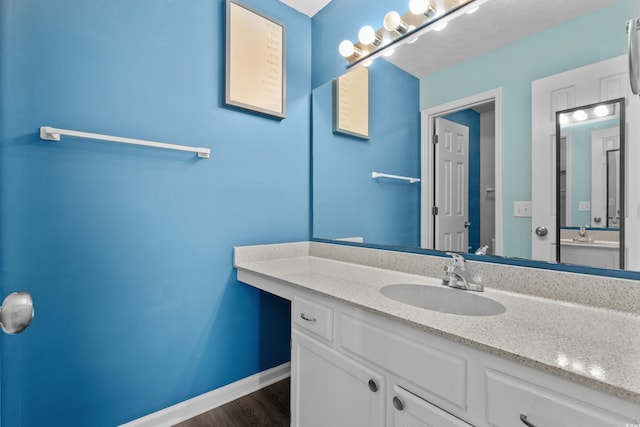 561 White River Dr Unit 11-D, Myrtle Beach, SC 29579 - bathroom featuring vanity, baseboards, and wood finished floors
