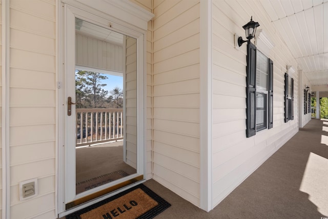 view of exterior entry featuring a porch