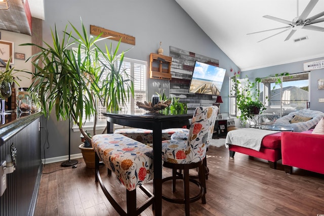 dining space featuring hardwood / wood-style floors, baseboards, visible vents, high vaulted ceiling, and ceiling fan