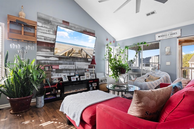 living room with visible vents, wood finished floors, a large fireplace, ceiling fan, and vaulted ceiling