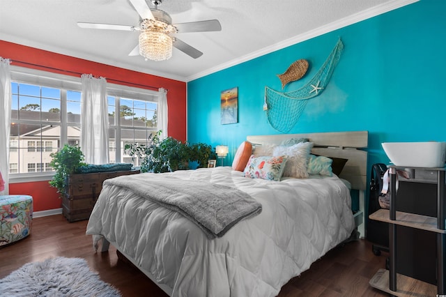 bedroom featuring baseboards, wood finished floors, a ceiling fan, and ornamental molding