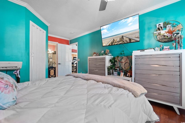 bedroom with a textured ceiling, wood finished floors, ceiling fan, and ornamental molding