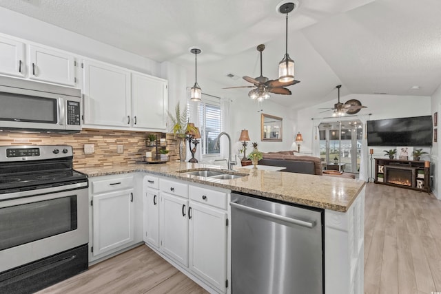 218 Landing Rd Unit G, North Myrtle Beach, SC 29582 - kitchen with appliances with stainless steel finishes, a peninsula, ceiling fan, light wood-style flooring, and open floor plan