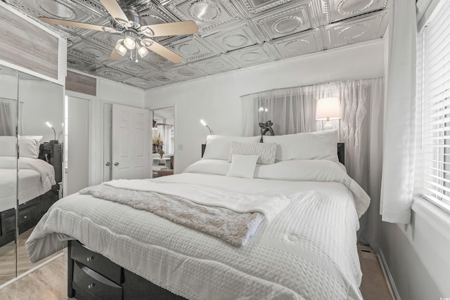 218 Landing Rd Unit G, North Myrtle Beach, SC 29582 - bedroom featuring an ornate ceiling, wood finished floors, a ceiling fan, and a closet