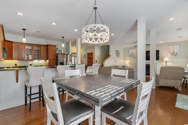 dining area featuring a chandelier, recessed lighting, and wood finished floors