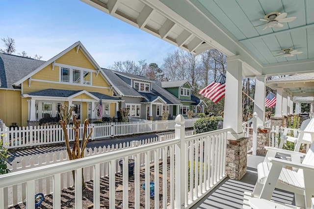 balcony featuring a ceiling fan, a residential view, and a porch