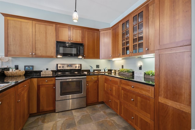 kitchen featuring brown cabinetry, black microwave, glass insert cabinets, and stainless steel electric range