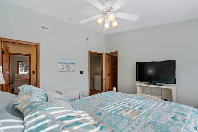 bedroom featuring a ceiling fan, visible vents, and vaulted ceiling