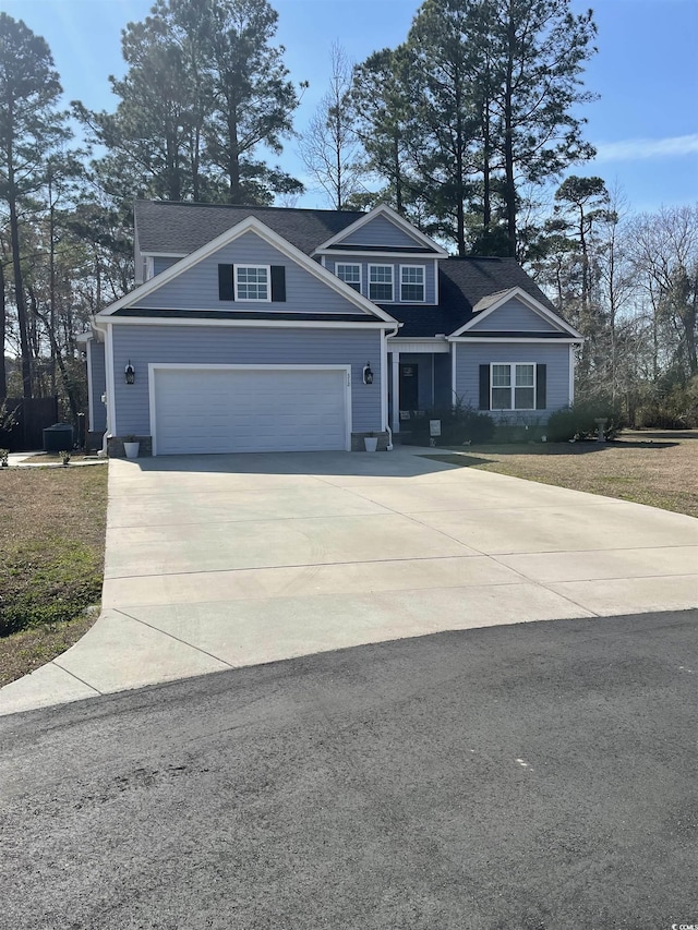 view of front of property with a garage and concrete driveway