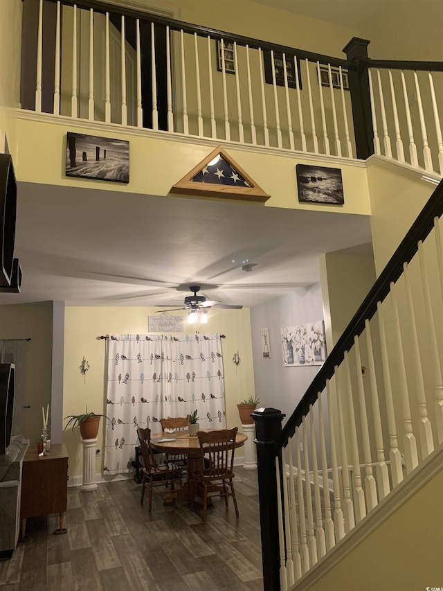 dining room featuring stairway, baseboards, wood finished floors, and a ceiling fan