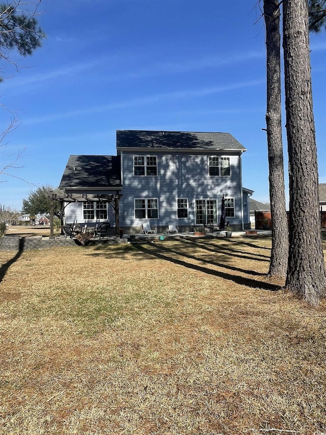 rear view of house featuring a yard