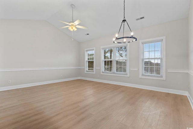 unfurnished dining area featuring light wood finished floors, a wealth of natural light, lofted ceiling, and visible vents