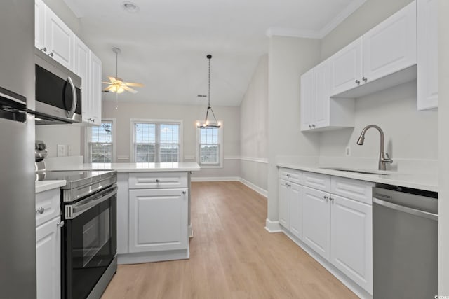 kitchen featuring white cabinetry, appliances with stainless steel finishes, light countertops, and a sink