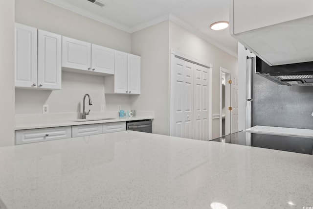 kitchen with light stone counters, a sink, white cabinets, and crown molding