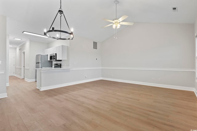 unfurnished living room featuring light wood-type flooring, baseboards, visible vents, and vaulted ceiling