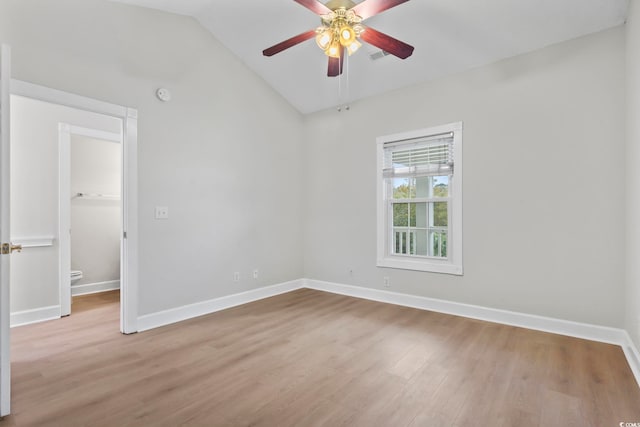 unfurnished room with light wood finished floors, lofted ceiling, visible vents, a ceiling fan, and baseboards