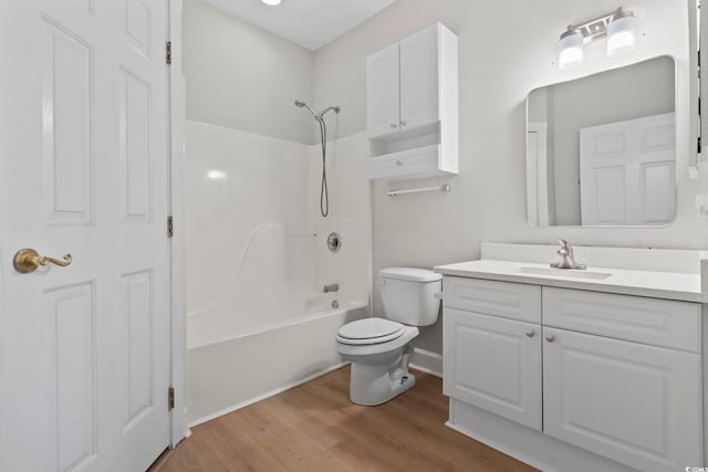 full bathroom with toilet, shower / bathtub combination, wood finished floors, and vanity