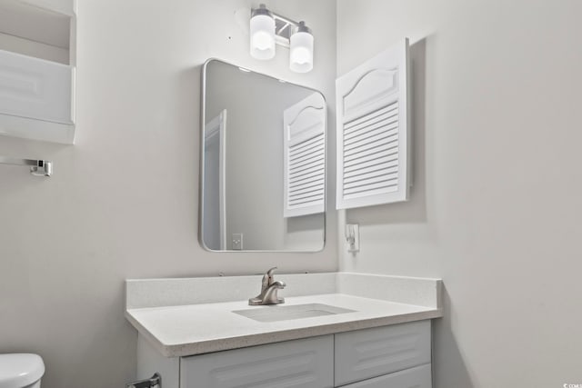 bathroom featuring toilet and vanity