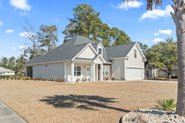 view of front of house featuring an attached garage, a front yard, concrete driveway, and roof with shingles