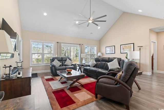 living room featuring baseboards, high vaulted ceiling, wood finished floors, and recessed lighting