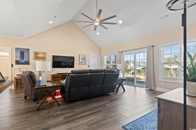 living area with visible vents, baseboards, a ceiling fan, dark wood-type flooring, and high vaulted ceiling