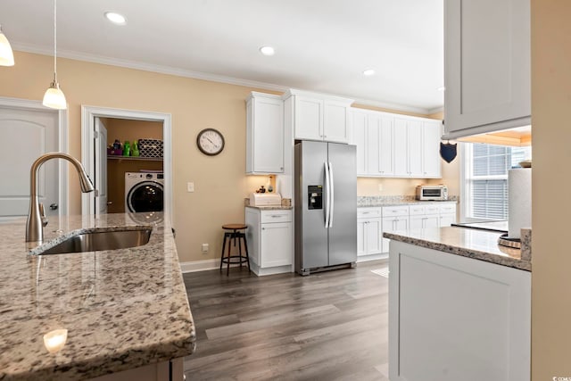 kitchen with a sink, washer / clothes dryer, stainless steel fridge, and crown molding