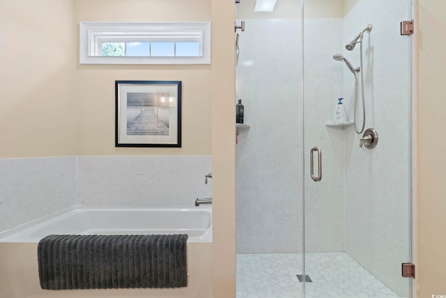 bathroom featuring a shower stall and a bath