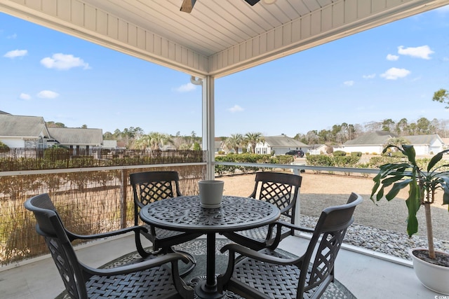 balcony featuring outdoor dining area, a patio area, and a ceiling fan