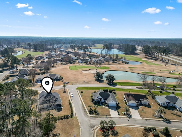 birds eye view of property with a water view and golf course view