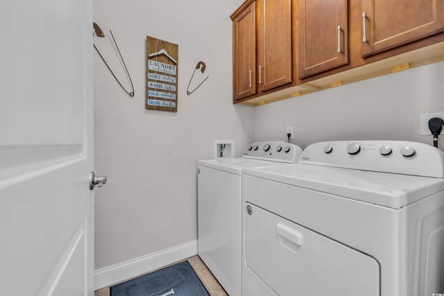 laundry room featuring light tile patterned flooring, cabinet space, independent washer and dryer, and baseboards