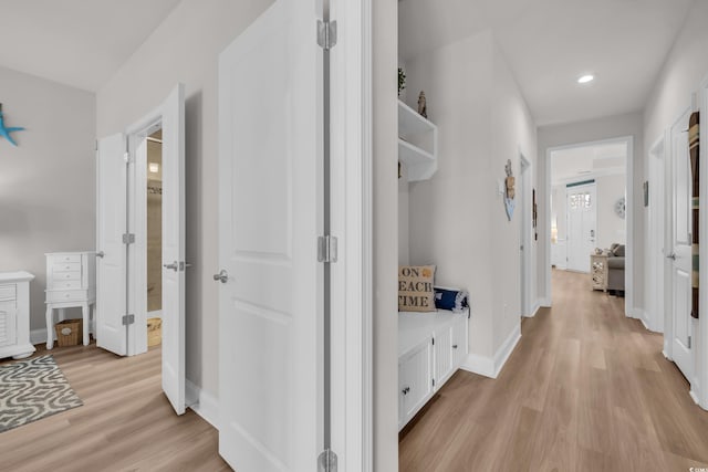 corridor featuring recessed lighting, baseboards, and light wood-style floors