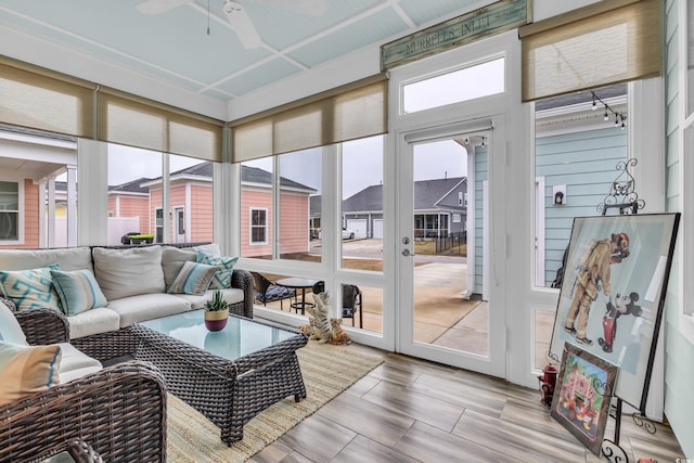 sunroom featuring ceiling fan