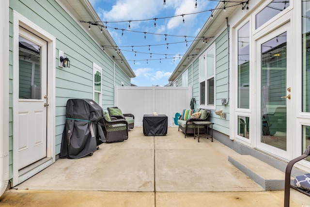 view of patio / terrace with area for grilling and fence