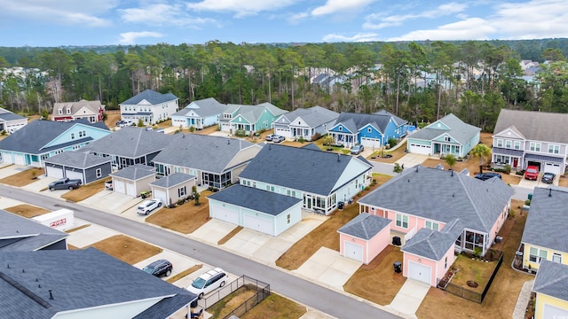 birds eye view of property with a view of trees and a residential view