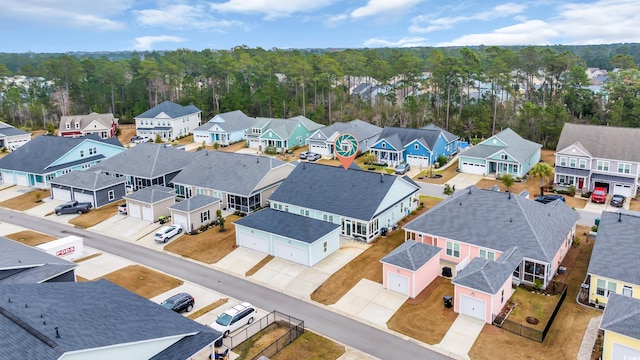 birds eye view of property featuring a residential view and a view of trees