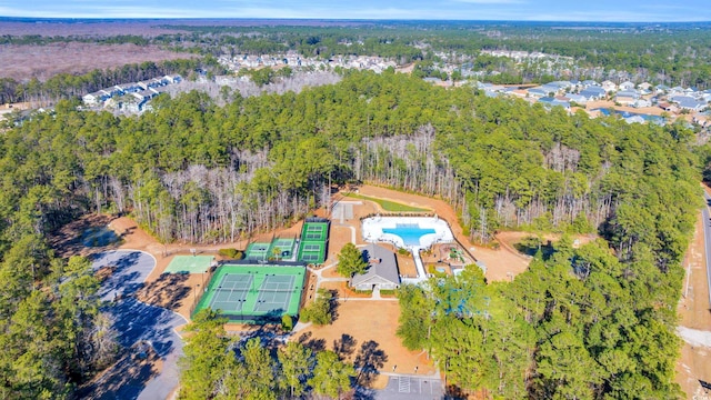 birds eye view of property featuring a view of trees