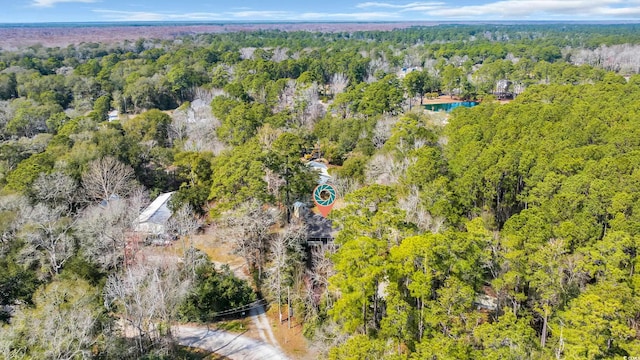 drone / aerial view with a wooded view