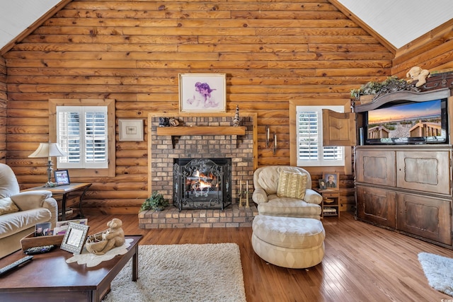 living room with high vaulted ceiling, rustic walls, a fireplace, and hardwood / wood-style floors