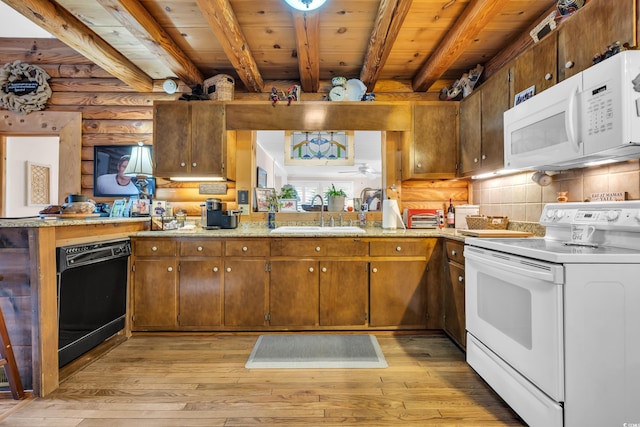 kitchen featuring white appliances, a sink, light wood-style flooring, and beam ceiling