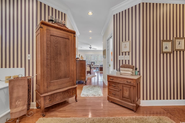 hallway featuring ornamental molding, recessed lighting, light wood-style flooring, and wallpapered walls