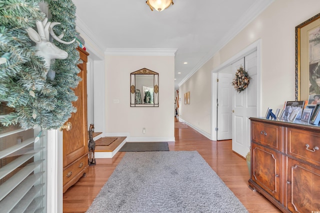 entrance foyer with light wood finished floors, baseboards, crown molding, and recessed lighting