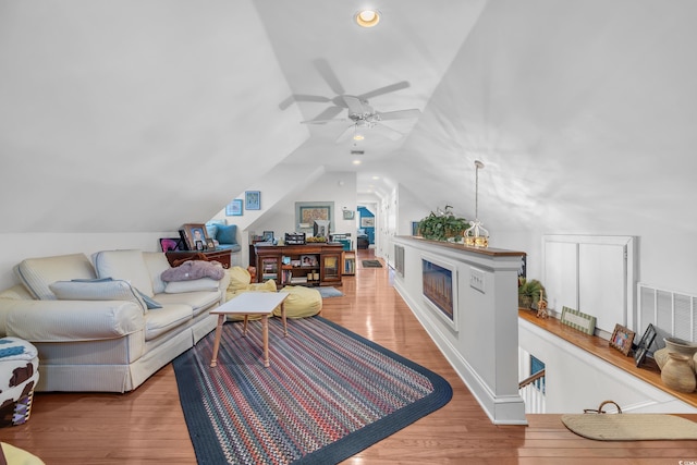 living area featuring visible vents, lofted ceiling, ceiling fan, wood finished floors, and recessed lighting