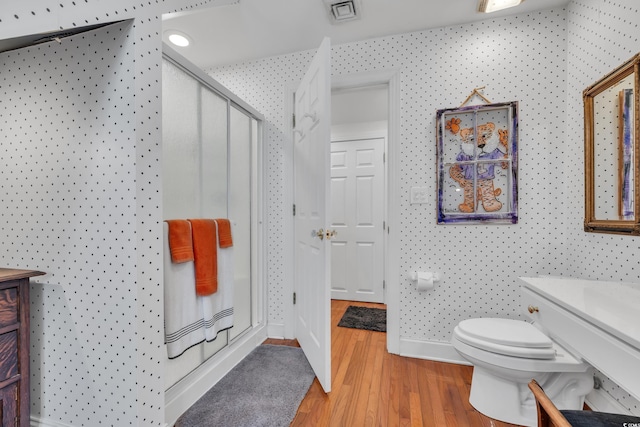 full bath with a shower stall, visible vents, wood finished floors, and vanity