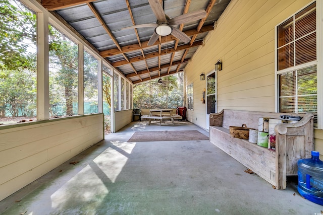 unfurnished sunroom with a ceiling fan