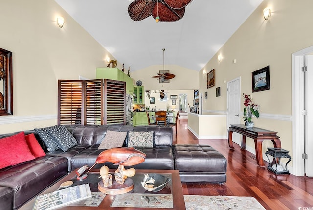 living area with high vaulted ceiling, ceiling fan, and wood finished floors