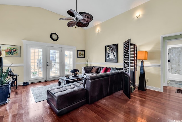 living room with french doors, visible vents, dark wood-type flooring, high vaulted ceiling, and baseboards